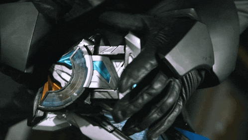 a person wearing a black glove is holding a metal object