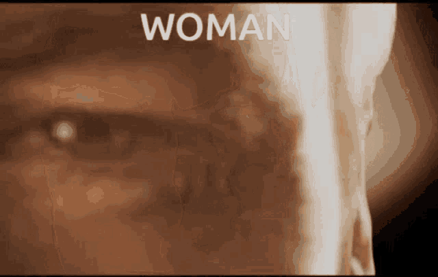 a close up of a man 's face with the word woman written on it