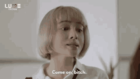 a woman with blonde hair and a white shirt is talking to another woman .