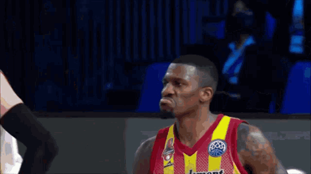a basketball player wearing a red and yellow jersey with the number 31 on it