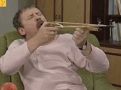 a man in a pink shirt is holding a bow and arrow