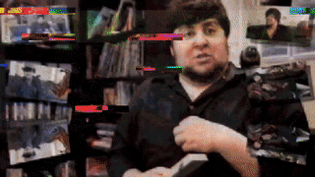 a blurry picture of a man holding a book in front of a shelf of books