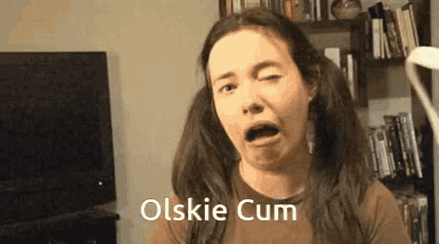 a woman with pigtails is making a funny face with the words olskie cum written on the bottom