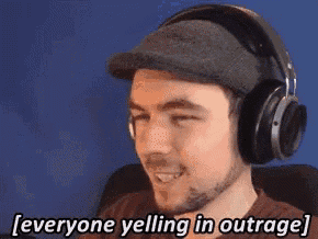 a man wearing headphones and a hat is smiling and yelling in outrage .