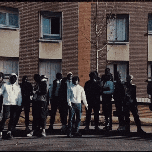 a group of people standing in front of a building
