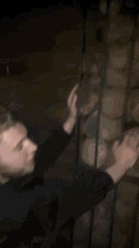 a blurry picture of a person reaching up to a ceiling
