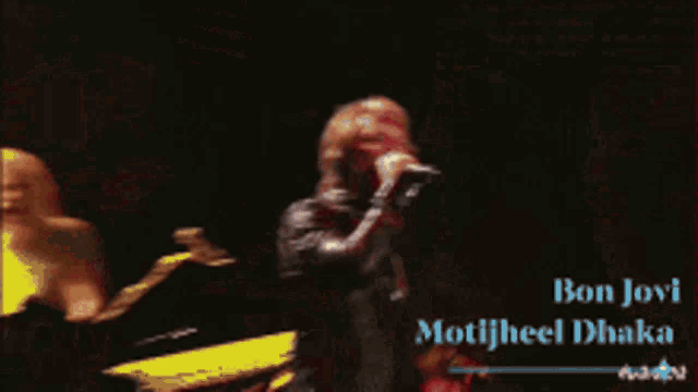 a man singing into a microphone with the words bon jovi motijheel chaka on the bottom
