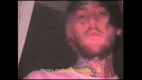 a man is laying in a coffin with the words `` money don 't help with the pain '' written on it .