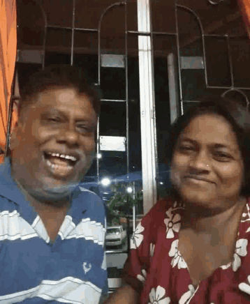 a man and woman are posing for a picture and smiling for the camera