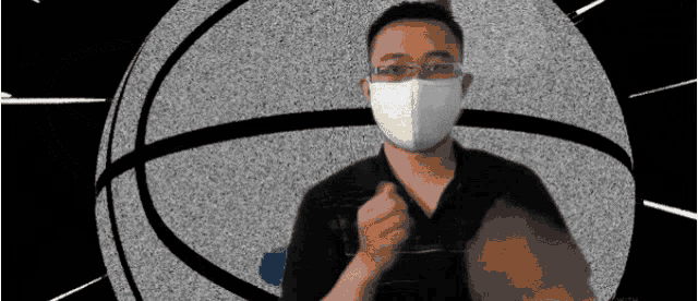 a man wearing a face mask is holding a basketball in front of a basketball