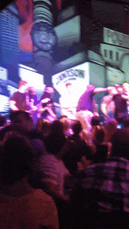a crowd of people are gathered in front of a screen that says ' nbc '