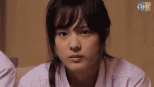 a close up of a girl 's face with the word one on the bottom right .