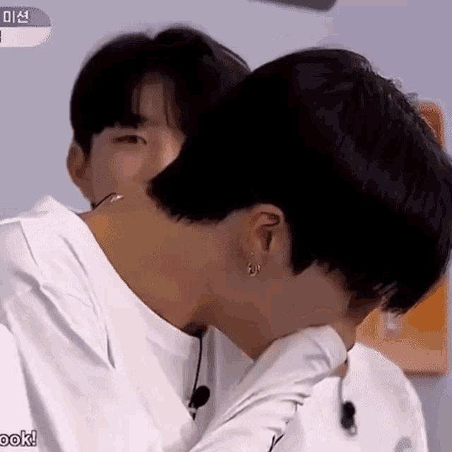 a close up of two men kissing each other on the neck .