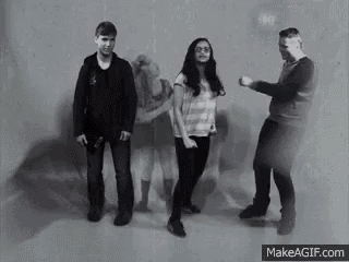 a black and white photo of a group of people dancing