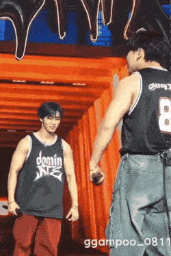 a man wearing a jersey that says domin on it stands next to another man