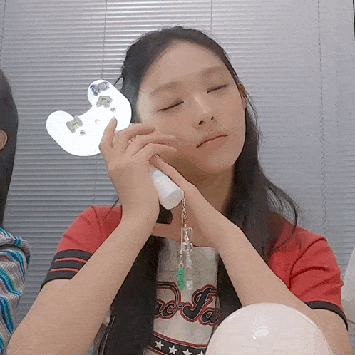 a girl wearing a red shirt that says ' rc ja ' on it
