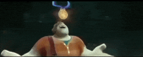 ralph from wreck it ralph is holding a gold medal in his hand .