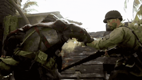 a man in a military uniform holds a gun to another man