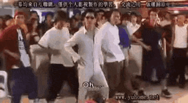 a group of people are dancing in a crowd .