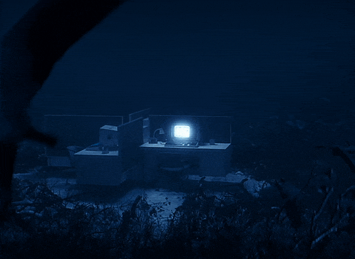 a dark underwater scene with a light shining on the bottom