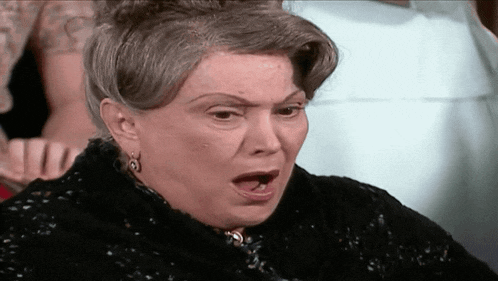 a woman with a surprised look on her face wearing earrings
