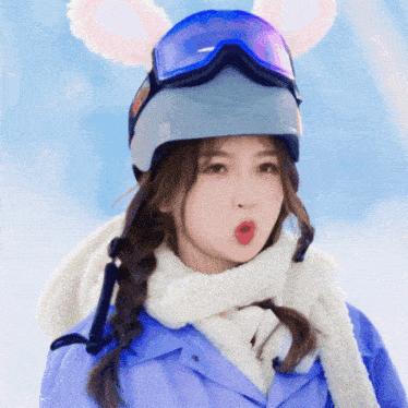 a woman wearing a ski helmet with bunny ears and goggles