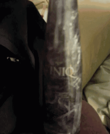 a bottle of iniq is sitting on a bed