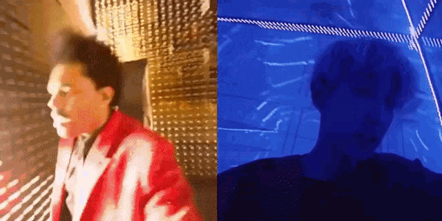 a man in a red jacket and a man in a blue shirt are standing next to each other in a dark room .