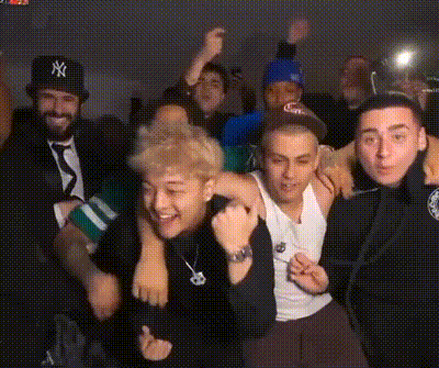 a man in a ny hat is surrounded by other men