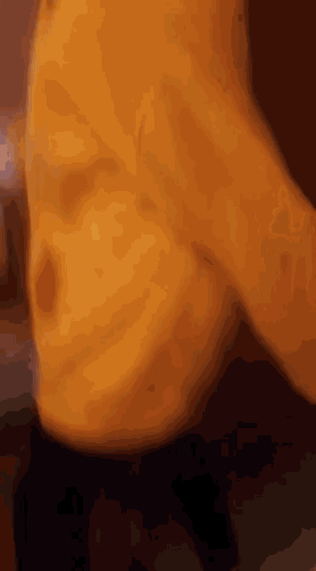 a close up of a person 's torso with a yellow shirt on .