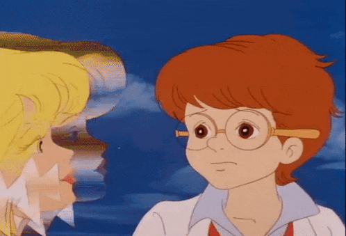 a boy with red hair and glasses is looking at a girl