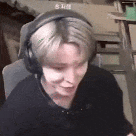 a man wearing headphones is sitting in front of a computer screen .