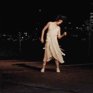 a woman wearing a white dress and white shoes