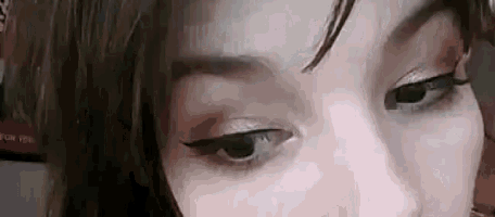 a close up of a woman 's eyes with makeup on looking at the camera .