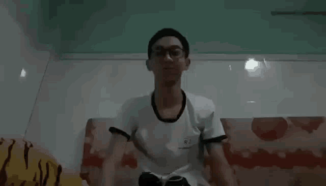 a man is doing push ups on a couch in a dark room .