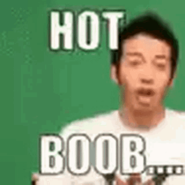 a man is holding a microphone and making a funny face with the words `` hot boob '' .