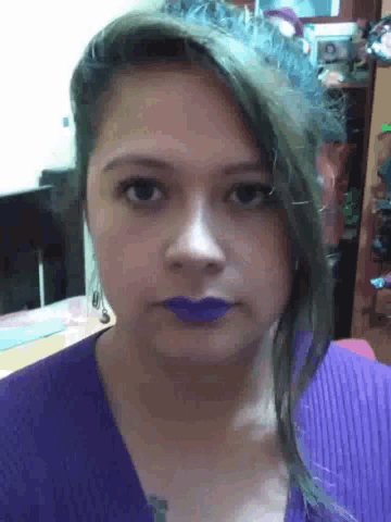 a woman with purple lipstick on her lips