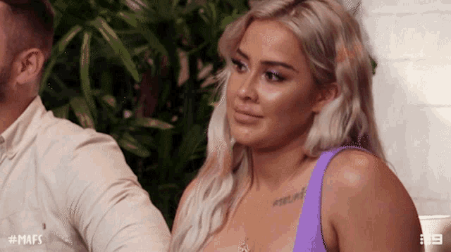 a woman in a purple top is sitting next to a man with the hashtag # mafs on the bottom
