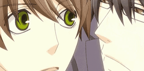 a couple of anime characters with green eyes are looking at each other .