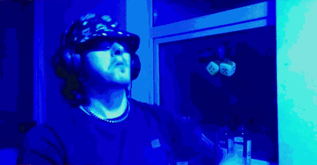 a man wearing headphones and a hat that says ' supreme ' on it