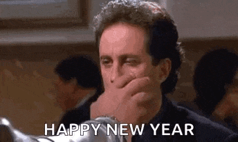 a man is covering his mouth with his hand and says `` happy new year '' .