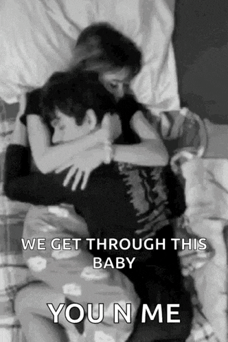 a black and white photo of a man and a woman hugging each other .