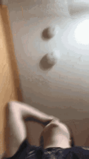 a person is laying on their back with their head on their hand