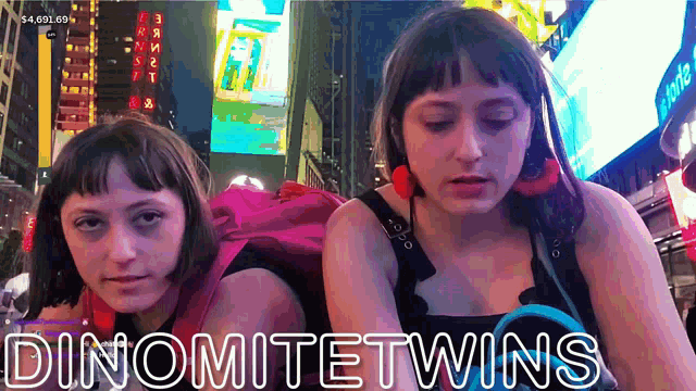 two girls are sitting next to each other and the words dinomitetwins are on the bottom right