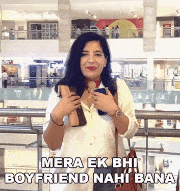 a woman in a white shirt is holding a purse and a cell phone with the caption mera ek bhi boyfriend nahi bana