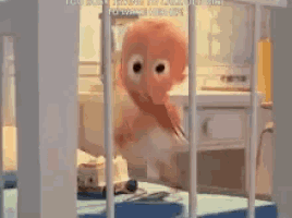 a baby in a diaper is standing in a crib in a room .