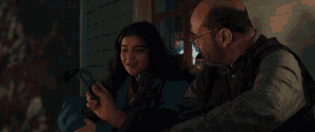 a man and a girl are sitting on a porch