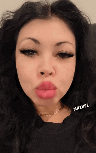 a close up of a woman 's face with the name mrznez on the bottom right