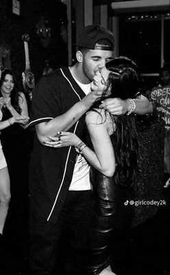 a man is kissing a woman in a black and white photo