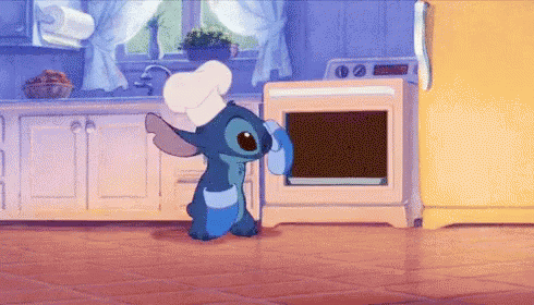 Stitch pulling a very airy chocolate cake that has risen to fill the entire inside of the oven, out of the oven.